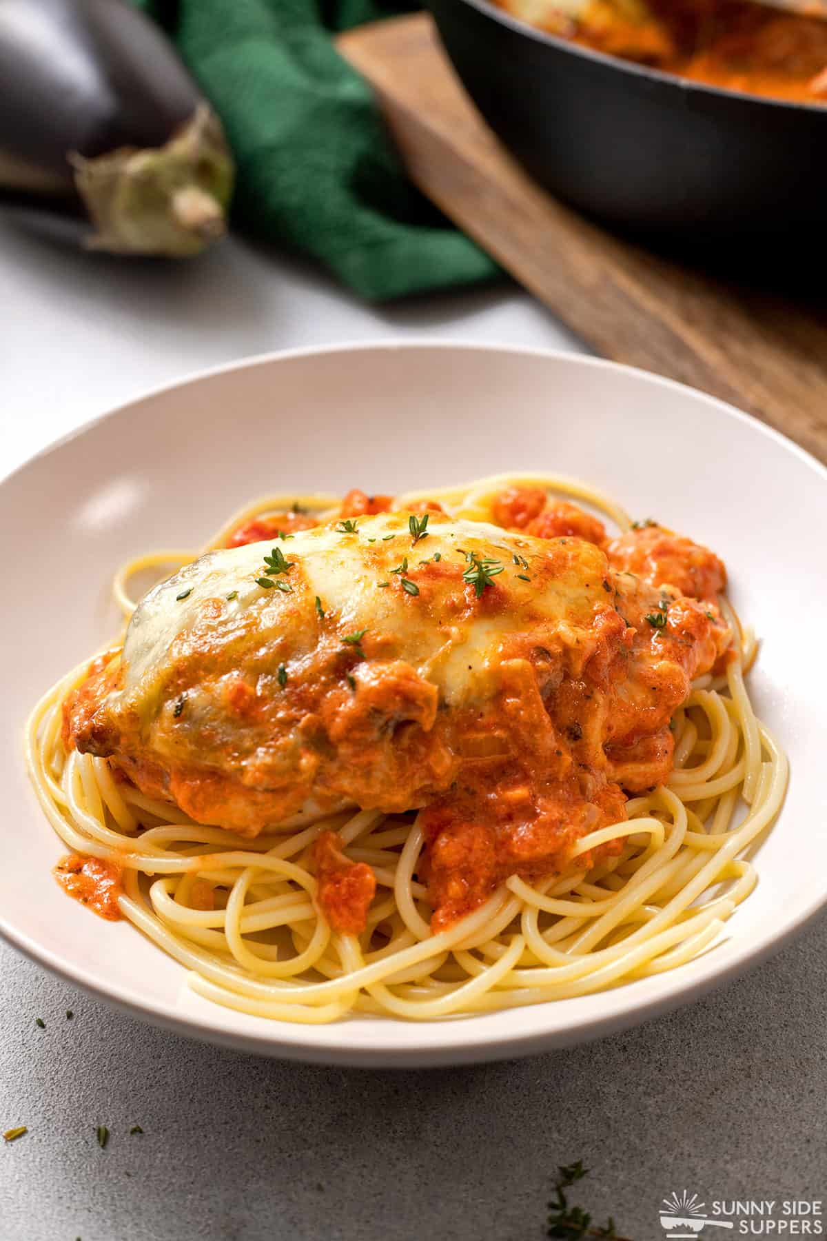 Chicken Sorrentino is served on a bed of spaghetti.