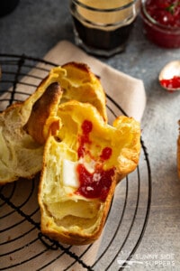 Popovers split in half with jam and butter.